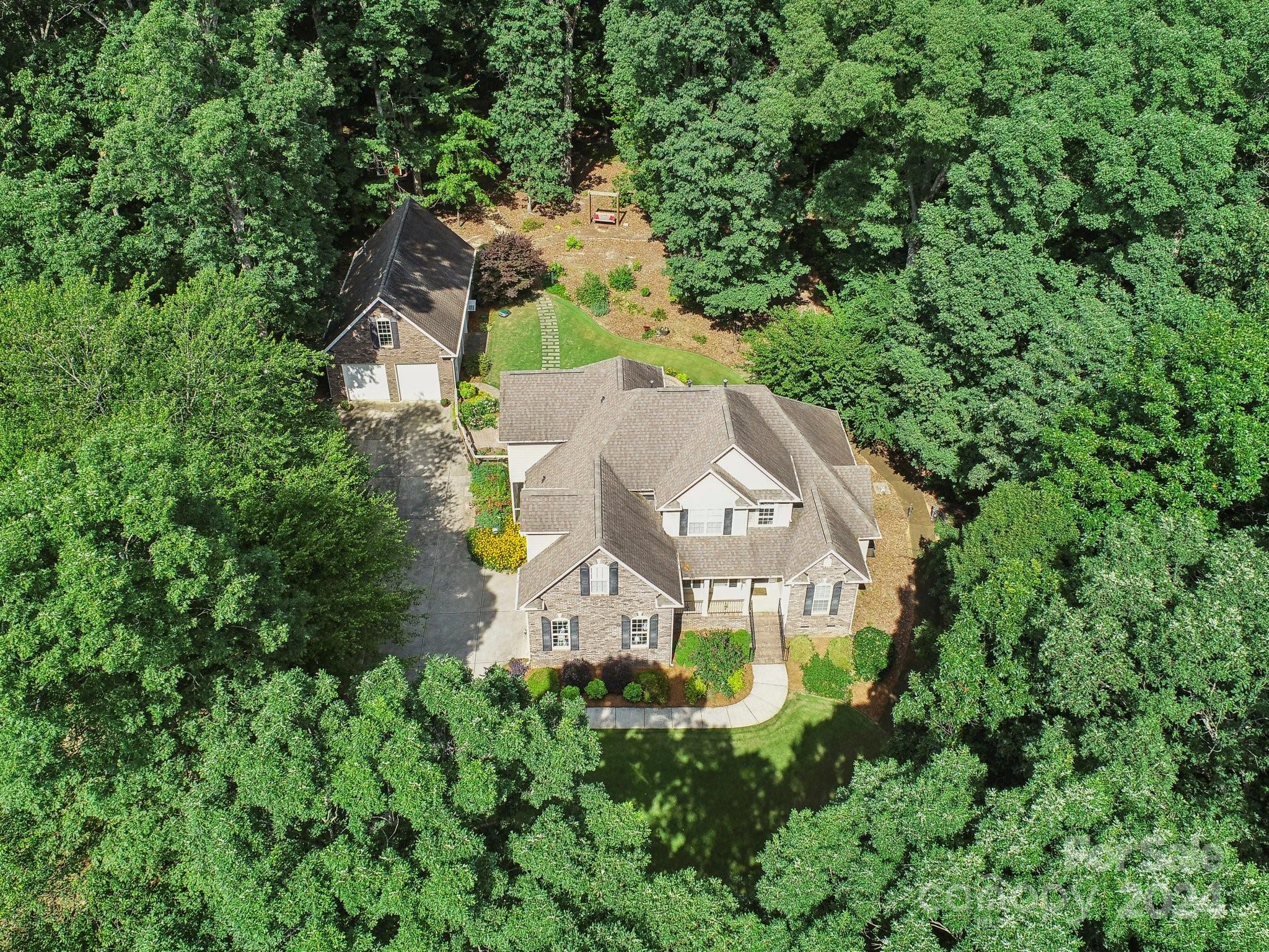 1013 Wesley Downs Road Monroe, NC 28110 - Photo 40 of 41 an aerial view of a house with a garden and trees