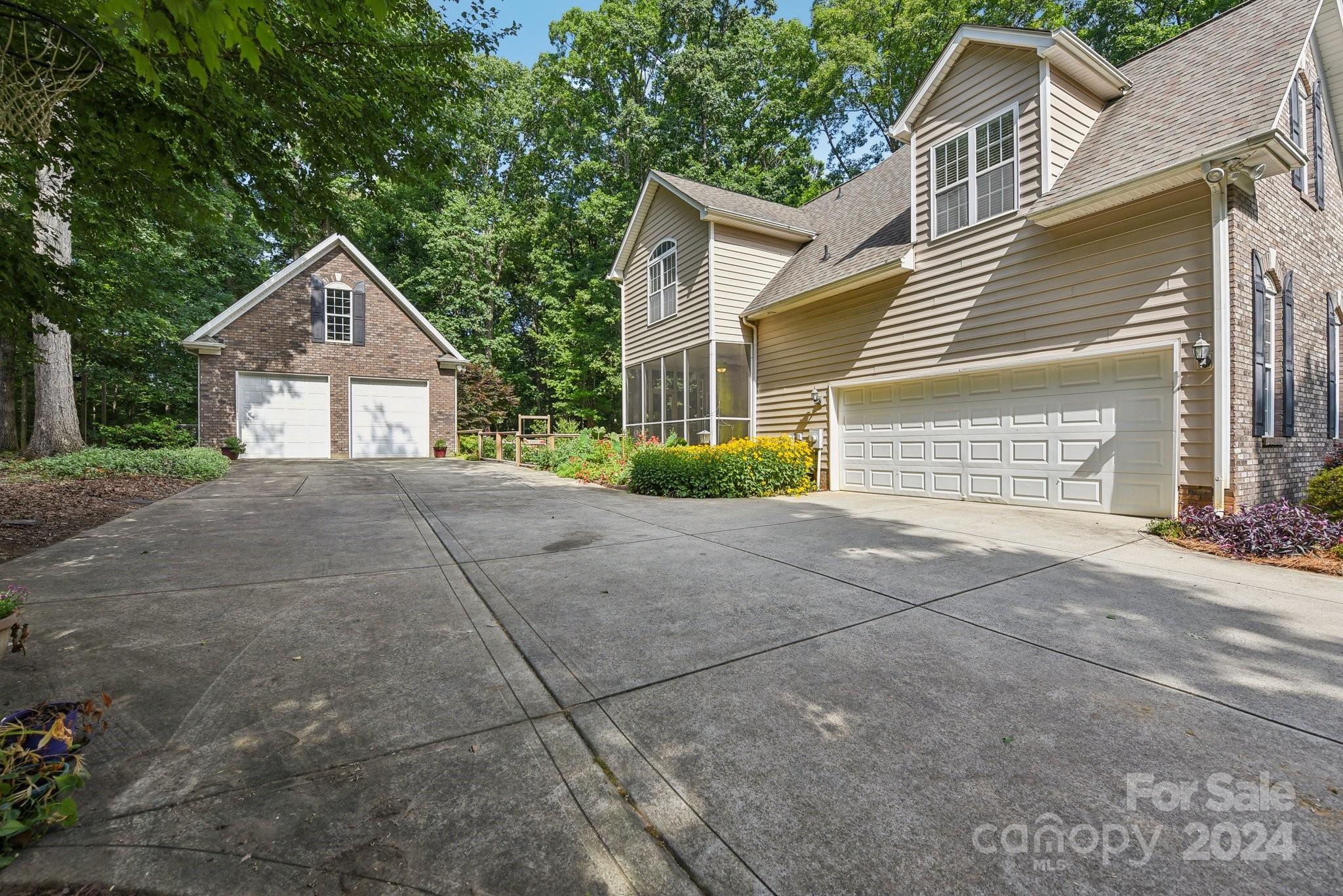 1013 Wesley Downs Road Monroe, NC 28110 - Photo 4 of 41 a front view of a house with a yard and garage