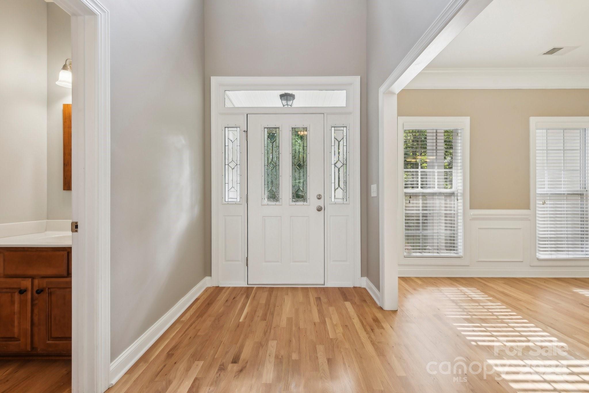 1013 Wesley Downs Road Monroe, NC 28110 - Photo 5 of 41 a view of a room with wooden floor and a bathroom
