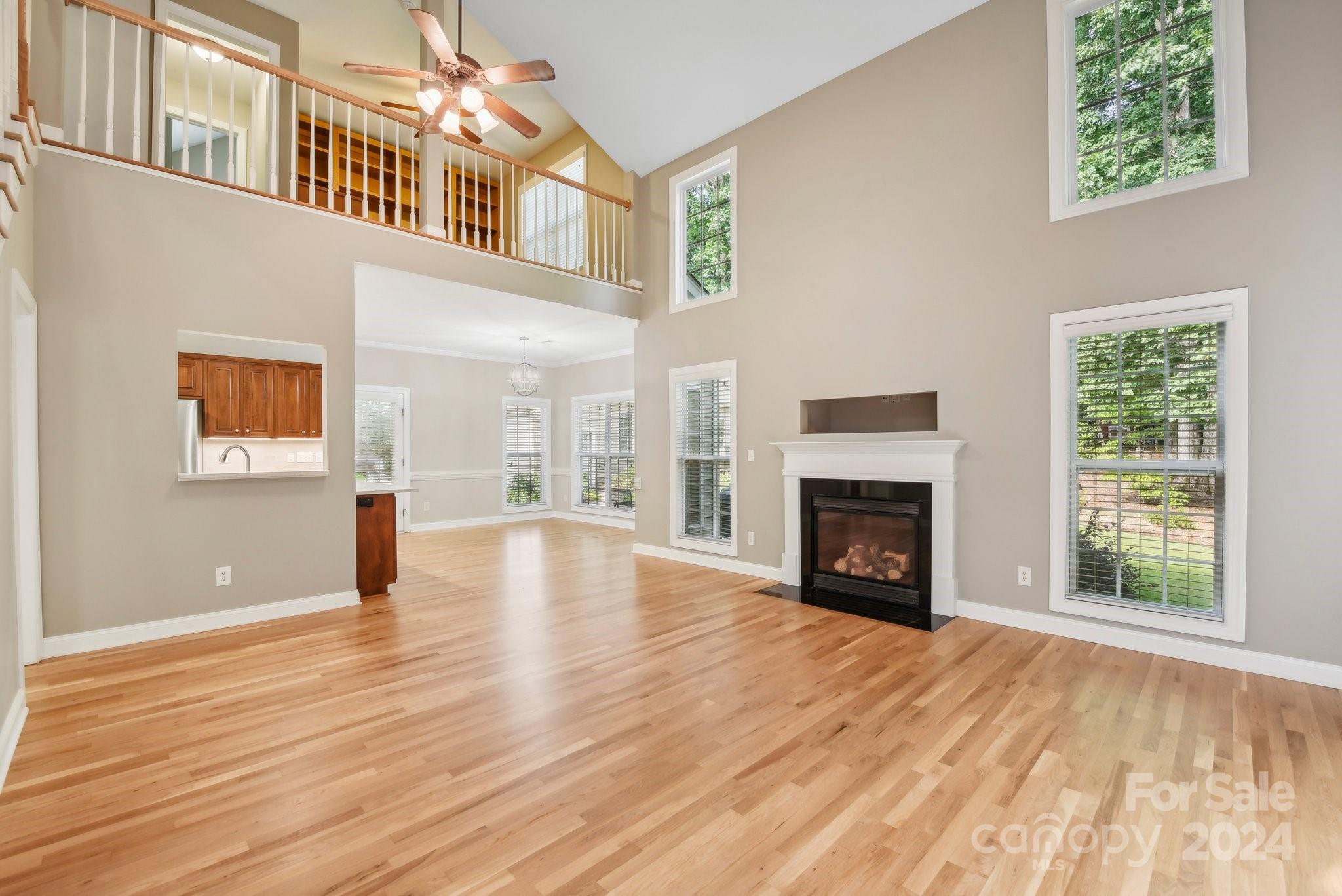 1013 Wesley Downs Road Monroe, NC 28110 - Photo 9 of 41 a view of an empty room with wooden floor fireplace and a window