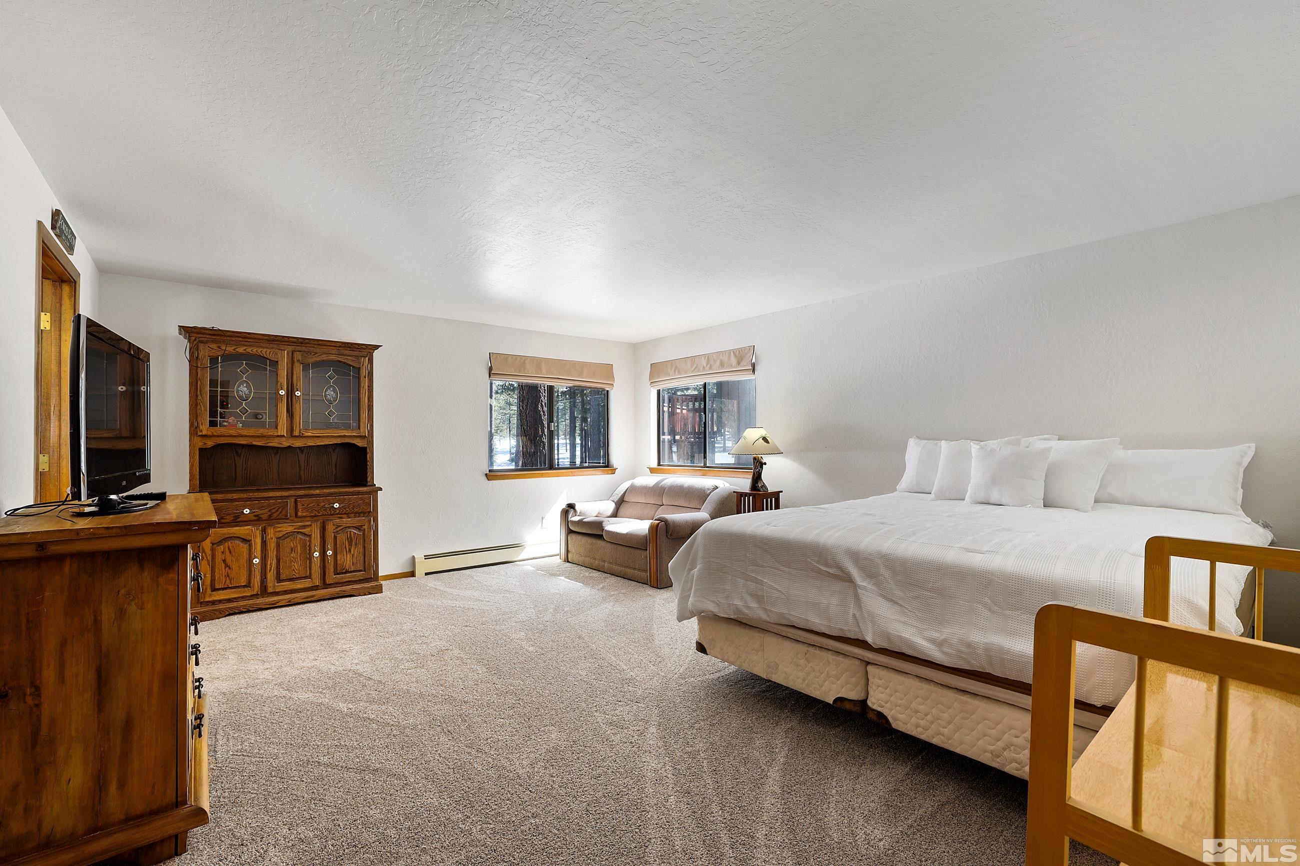 84 Rubicon Circle North, Unit C Stateline, NV 89449 - Photo 11 of 22 a bedroom with furniture and a flat screen tv