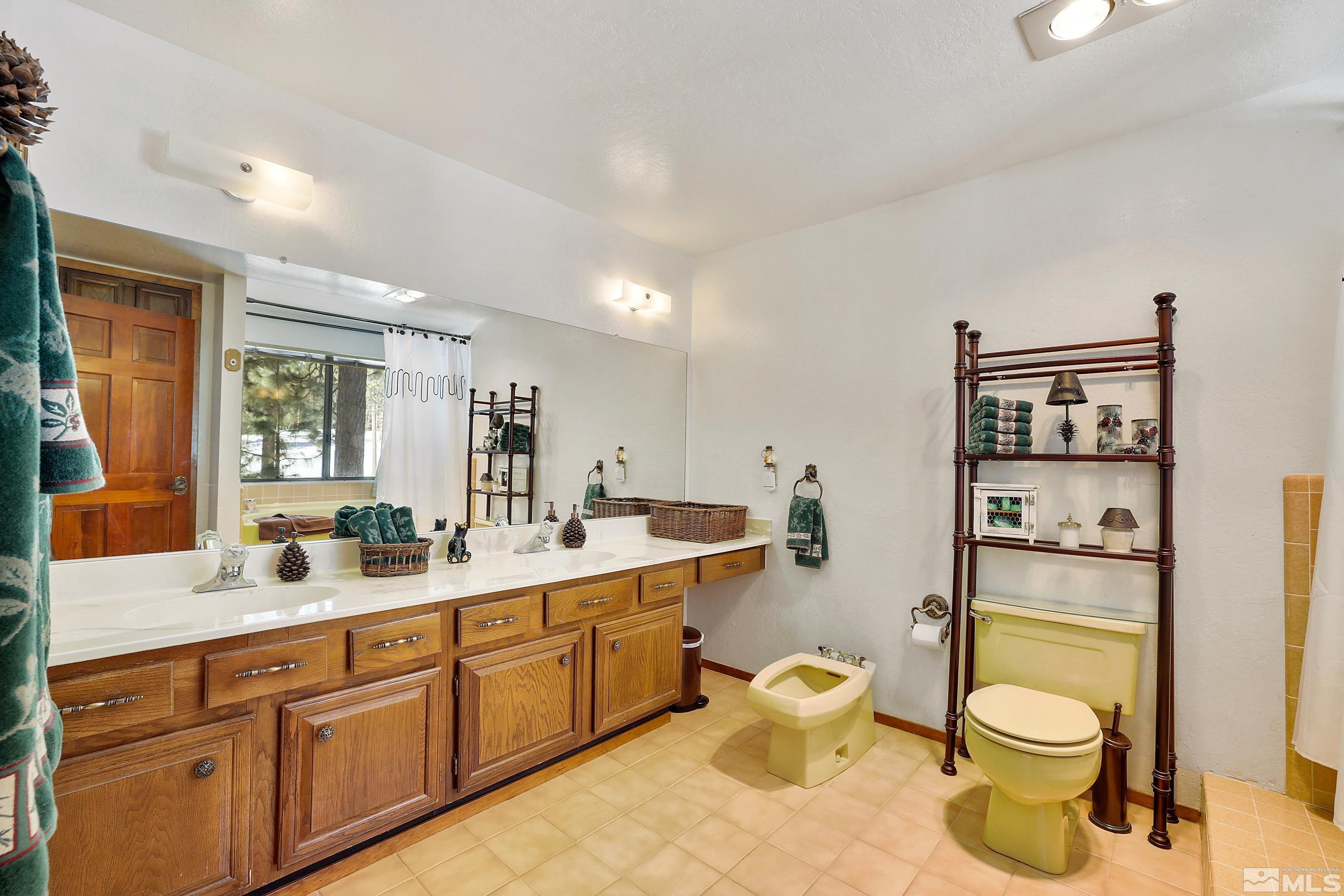 84 Rubicon Circle North, Unit C Stateline, NV 89449 - Photo 13 of 22 a bathroom with a toilet sink and mirror