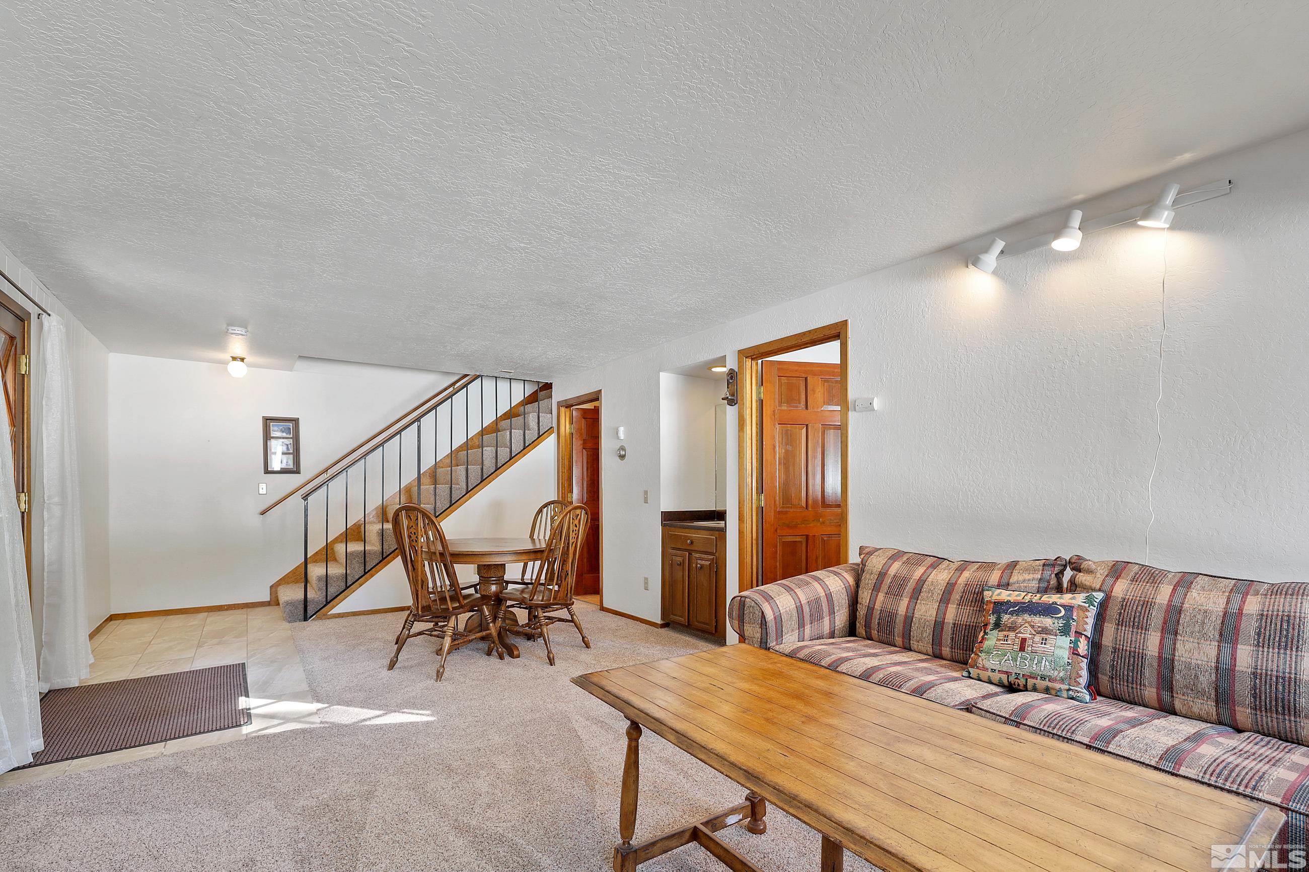84 Rubicon Circle North, Unit C Stateline, NV 89449 - Photo 16 of 22 a living room with furniture and stairs