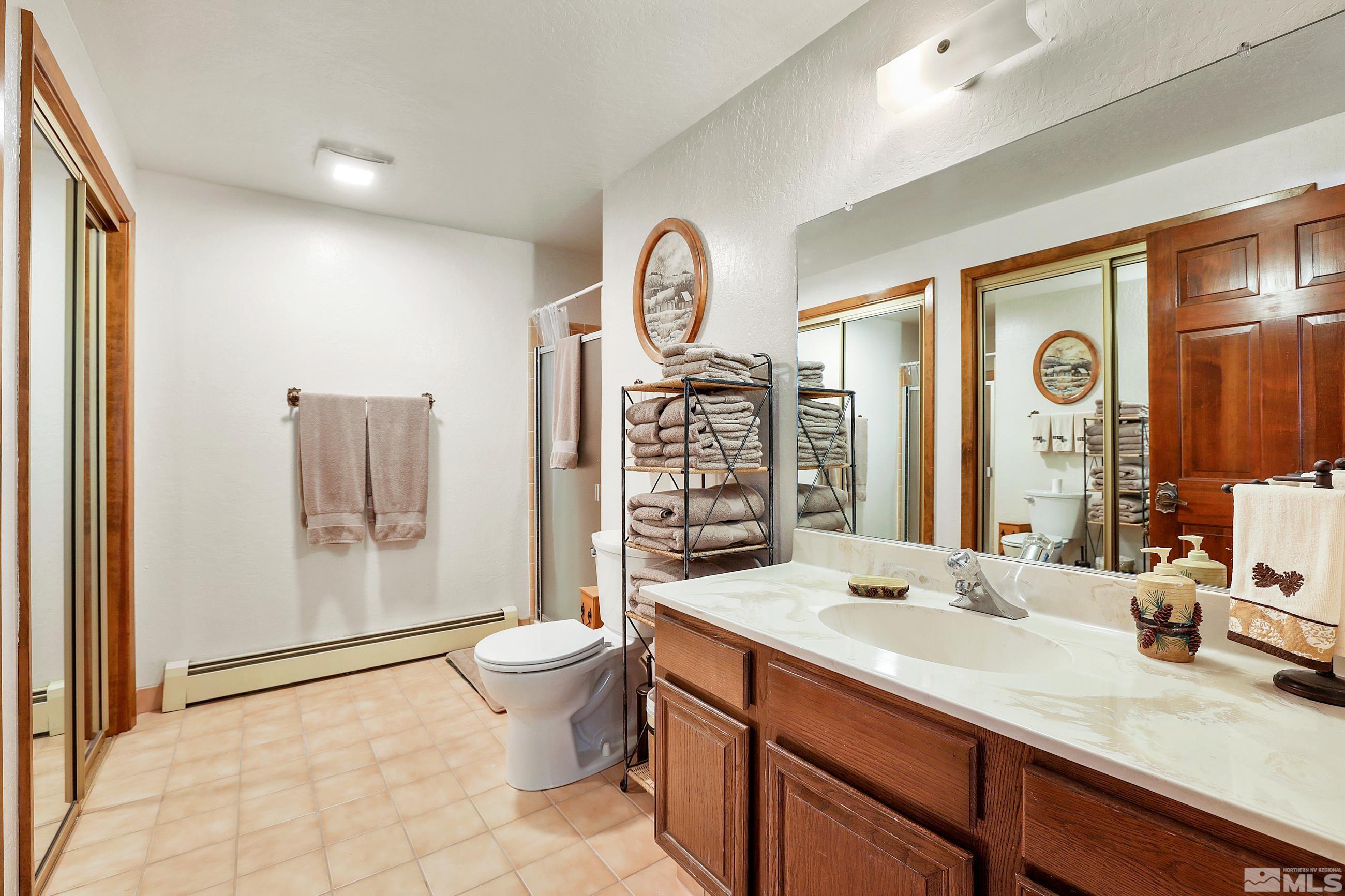 84 Rubicon Circle North, Unit C Stateline, NV 89449 - Photo 17 of 22 a spacious bathroom with a toilet a sink and a large mirror
