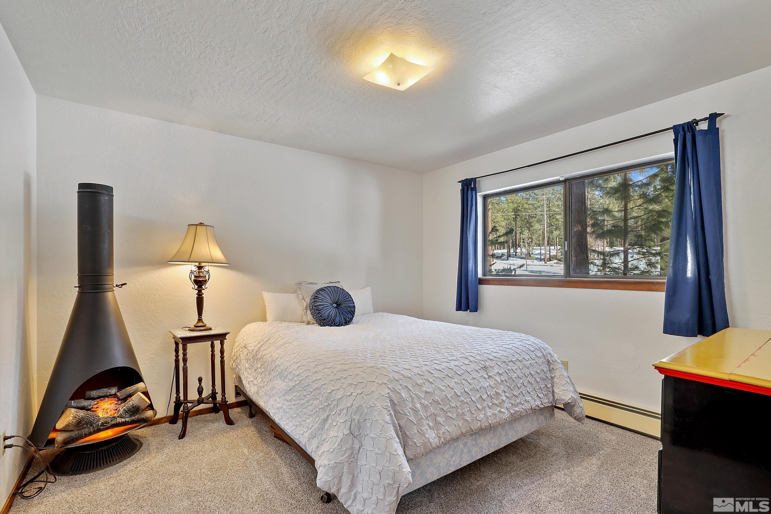 84 Rubicon Circle North, Unit C Stateline, NV 89449 - Photo 18 of 22 a bedroom with a bed and window