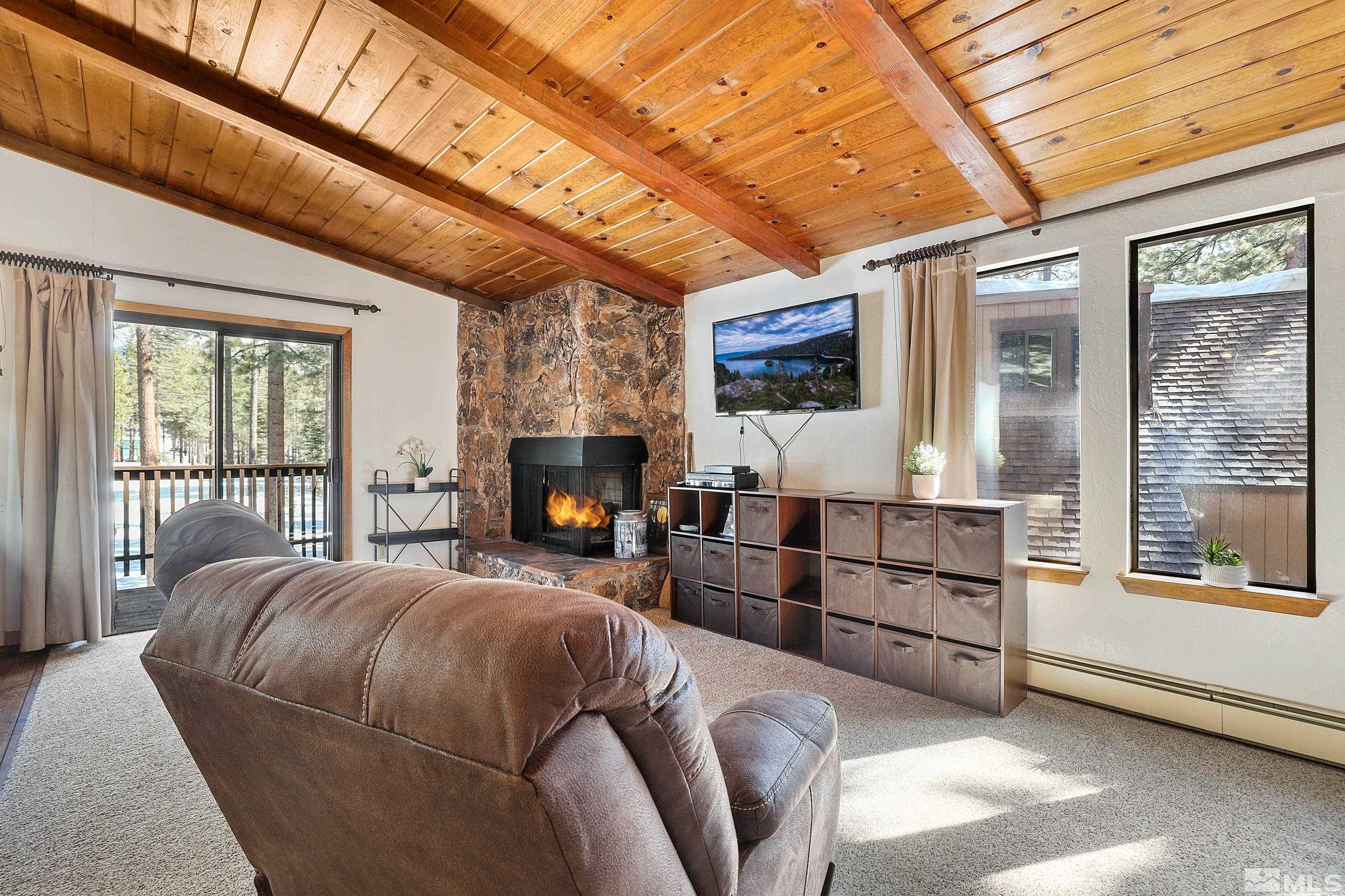 84 Rubicon Circle North, Unit C Stateline, NV 89449 - Photo 3 of 22 a bedroom with furniture and a fireplace