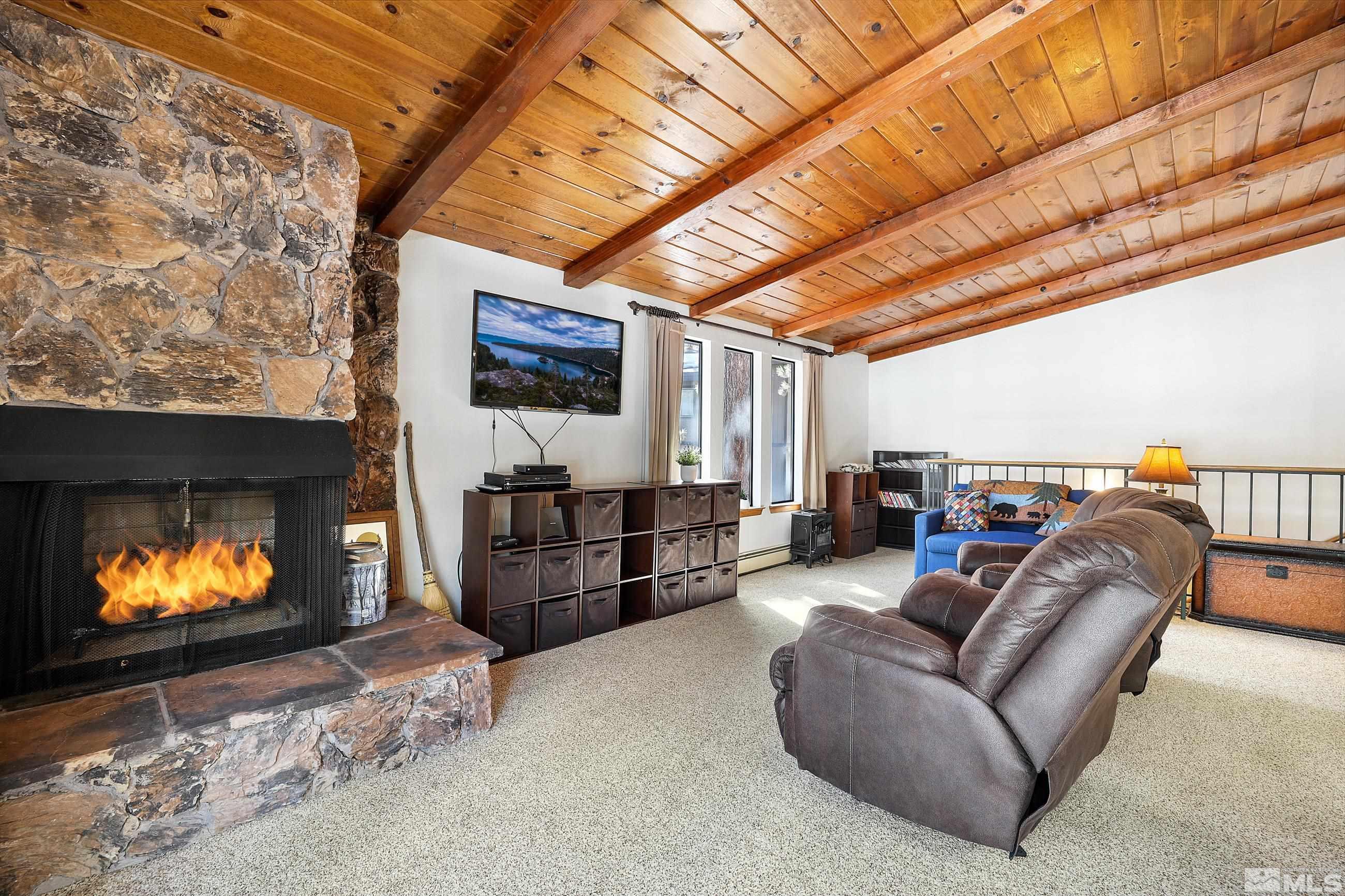 84 Rubicon Circle North, Unit C Stateline, NV 89449 - Photo 4 of 22 a living room with furniture a flat screen tv and a fireplace