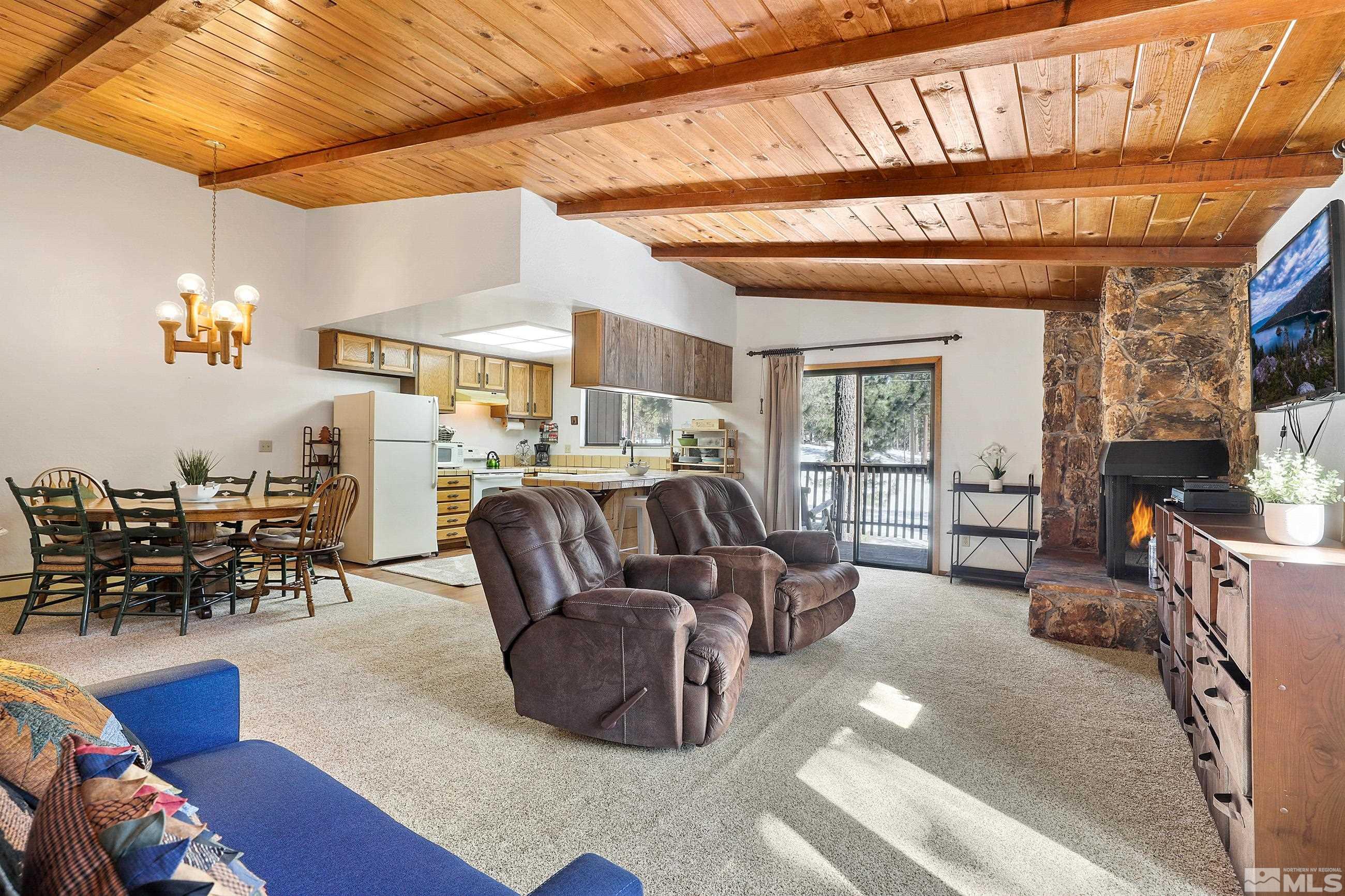 84 Rubicon Circle North, Unit C Stateline, NV 89449 - Photo 6 of 22 a living room with furniture and a chandelier