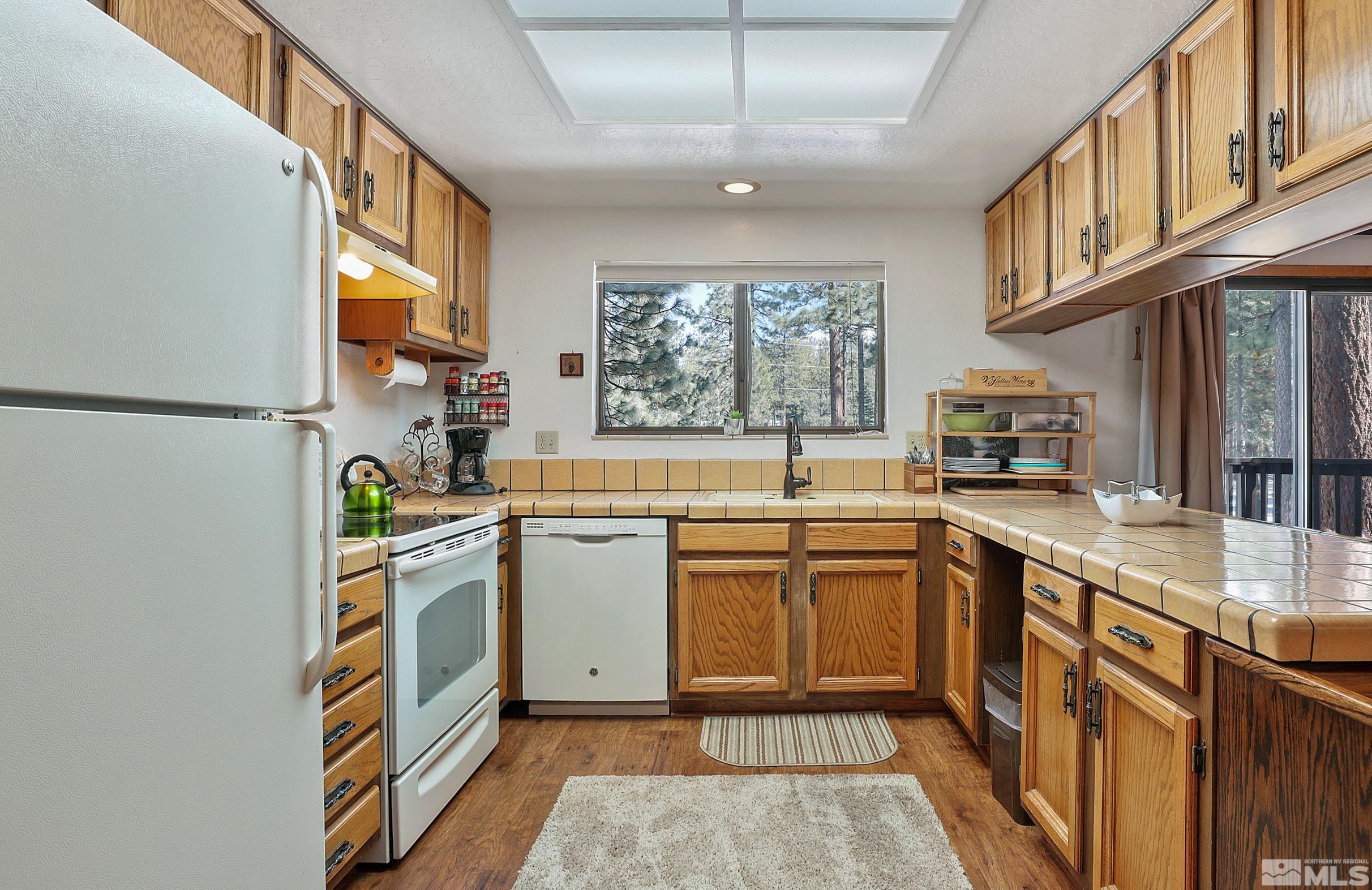 84 Rubicon Circle North, Unit C Stateline, NV 89449 - Photo 7 of 22 a kitchen with stainless steel appliances granite countertop a sink and a stove