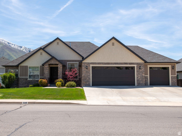 646 East 1400th Street North Mapleton, UT 84664 - Photo 1 of 78 Contemporary single-story residence featuring a stone and siding facade, a dark shingle roof, and an attached three-car garage