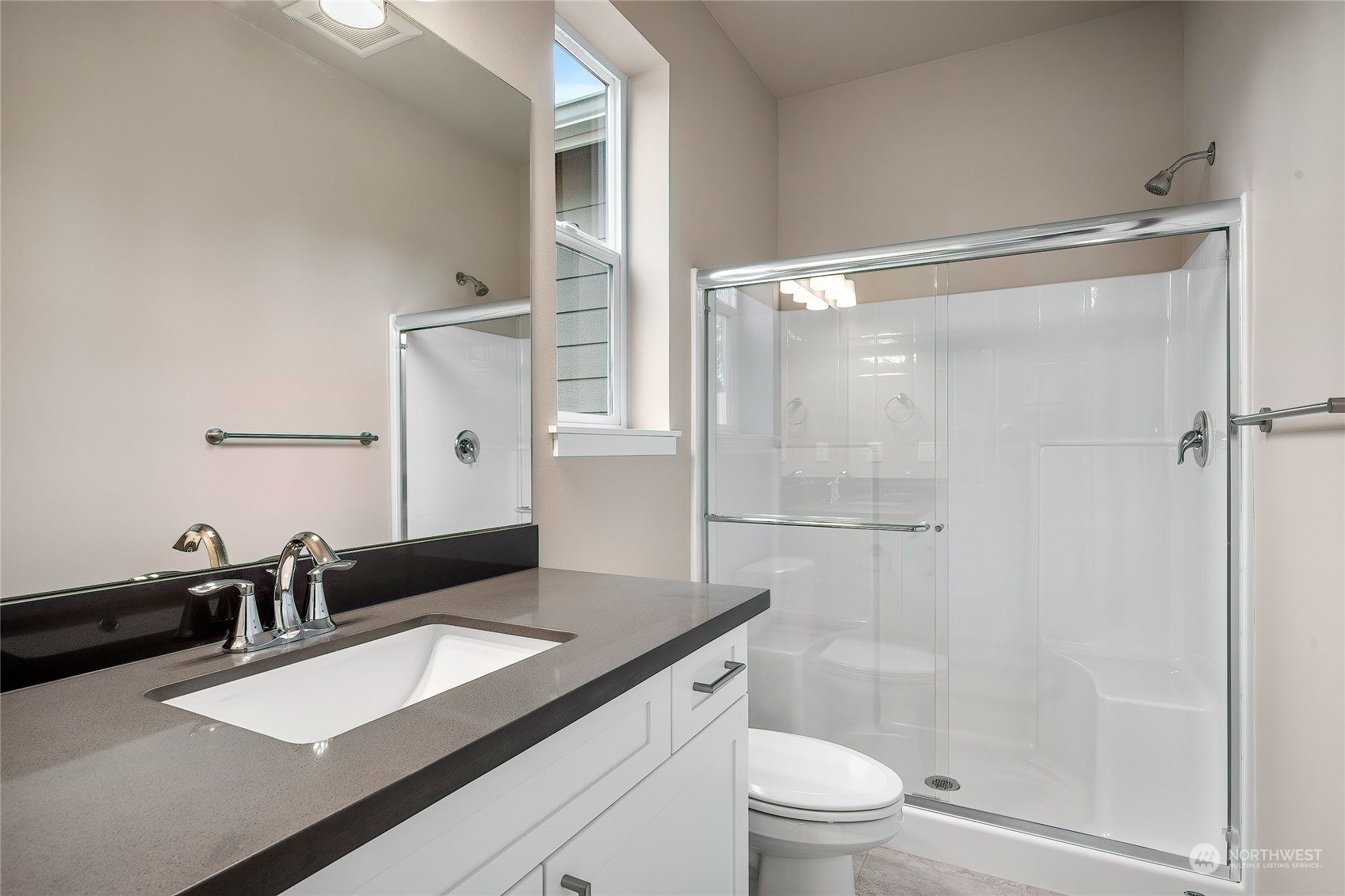 24230 Brier Road Brier, WA 98036 - Photo 16 of 40 a bathroom with a granite countertop sink toilet and shower