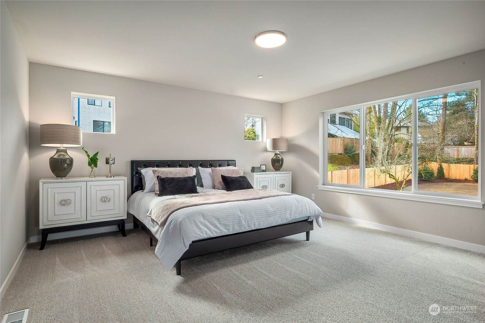 24230 Brier Road Brier, WA 98036 - Photo 20 of 40 a spacious bedroom with a bed and a large window