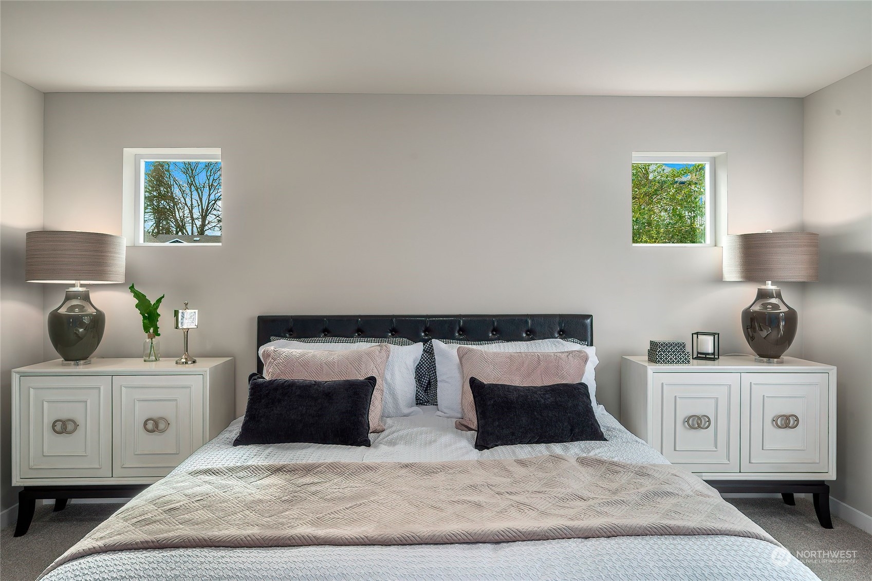 24230 Brier Road Brier, WA 98036 - Photo 21 of 40 a bedroom with a large bed and a lamp on dresser