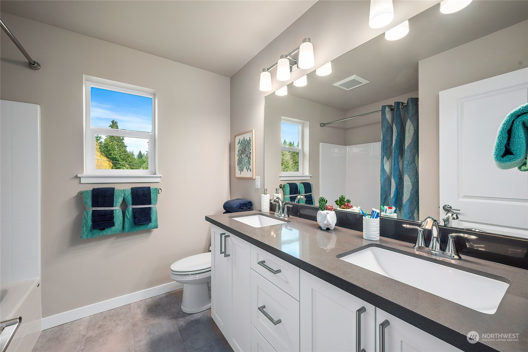 24230 Brier Road Brier, WA 98036 - Photo 27 of 40 a spacious bathroom with a granite countertop sink a toilet a mirror and a window