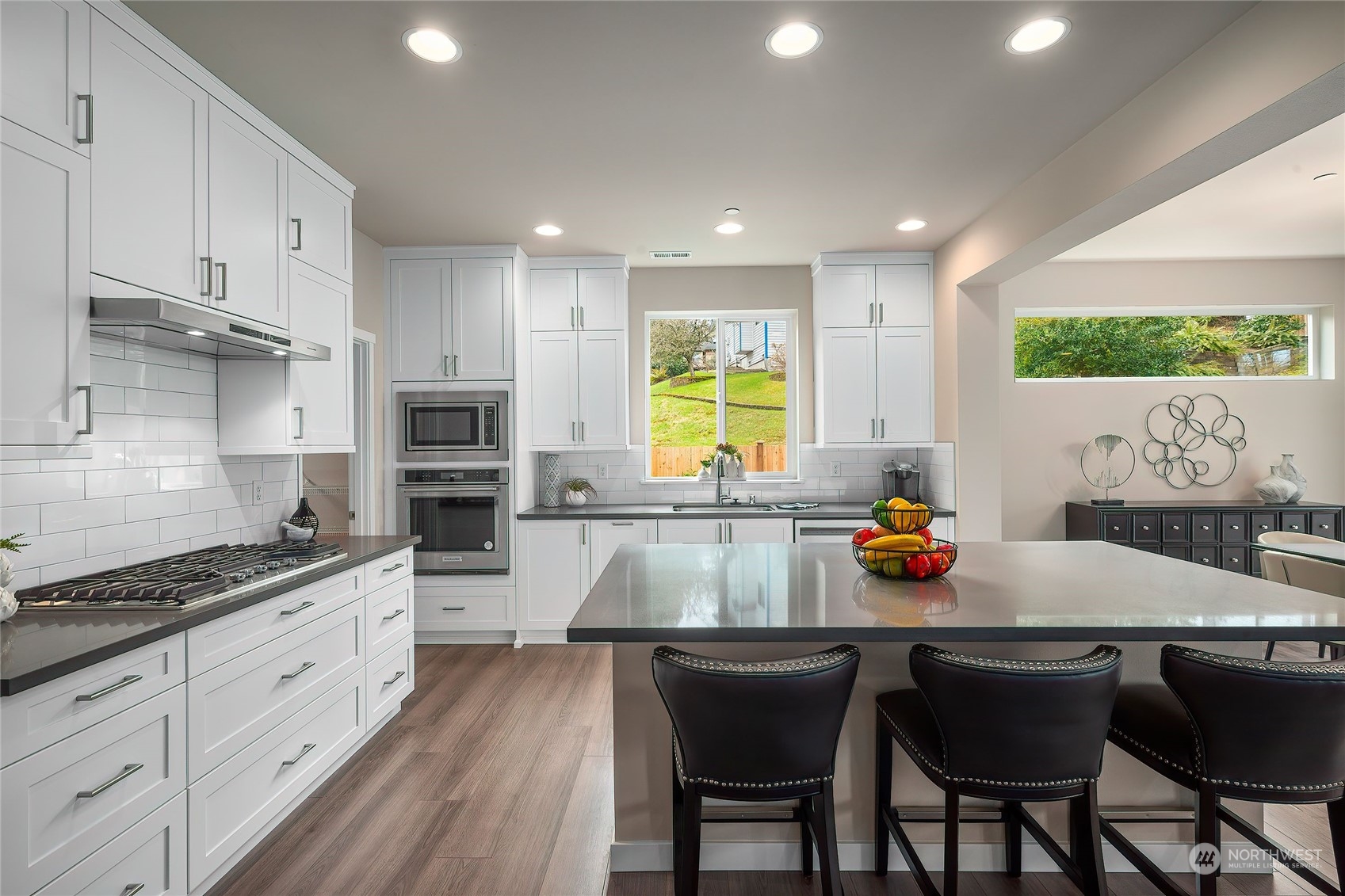 24230 Brier Road Brier, WA 98036 - Photo 6 of 40 a kitchen with stainless steel appliances granite countertop a stove a sink a microwave and white cabinets