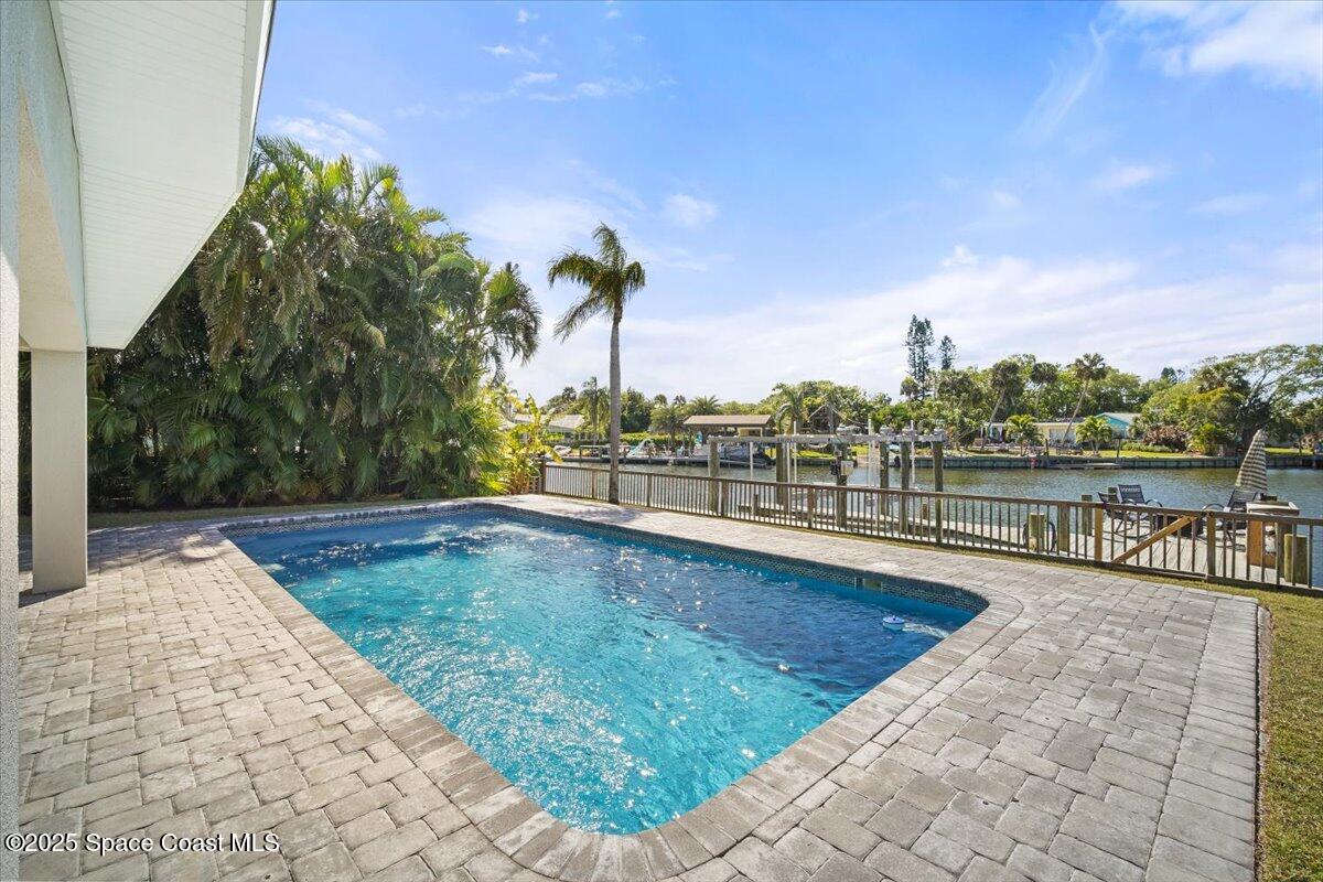 1125 Samar Road Cocoa Beach, FL 32931 - Photo 21 of 46 a view of a swimming pool with a lounge chair