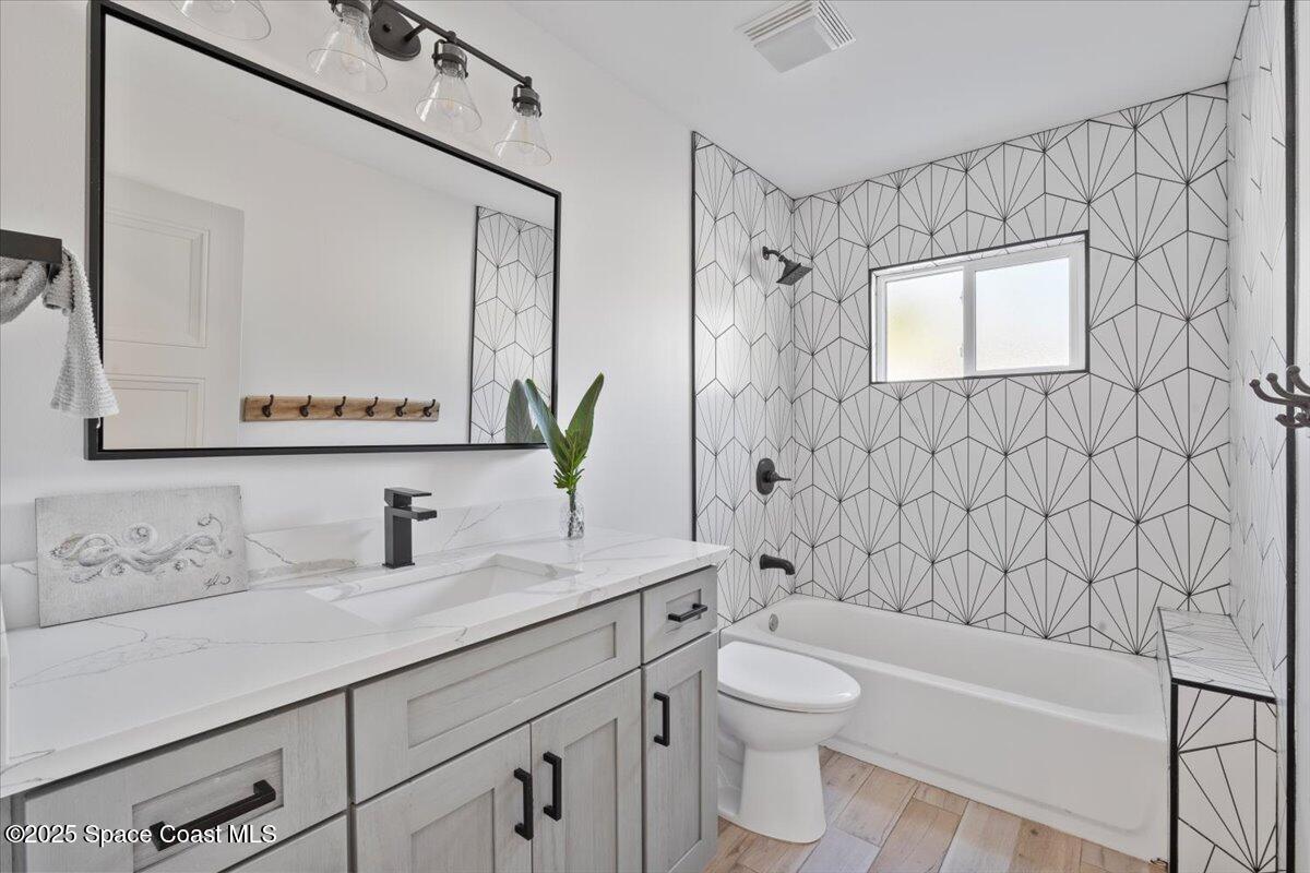 1125 Samar Road Cocoa Beach, FL 32931 - Photo 29 of 46 a bathroom with a sink a toilet and shower
