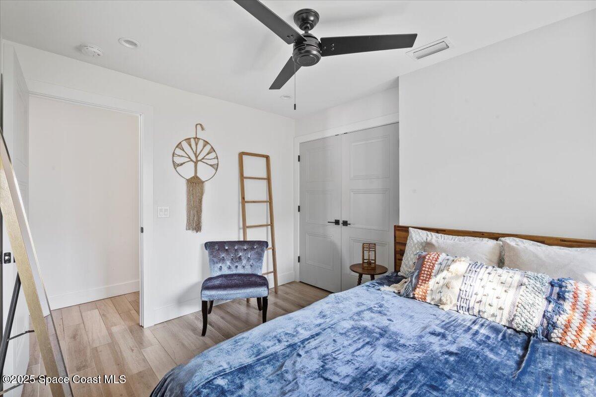 1125 Samar Road Cocoa Beach, FL 32931 - Photo 35 of 46 a bedroom with a bed and a table in it