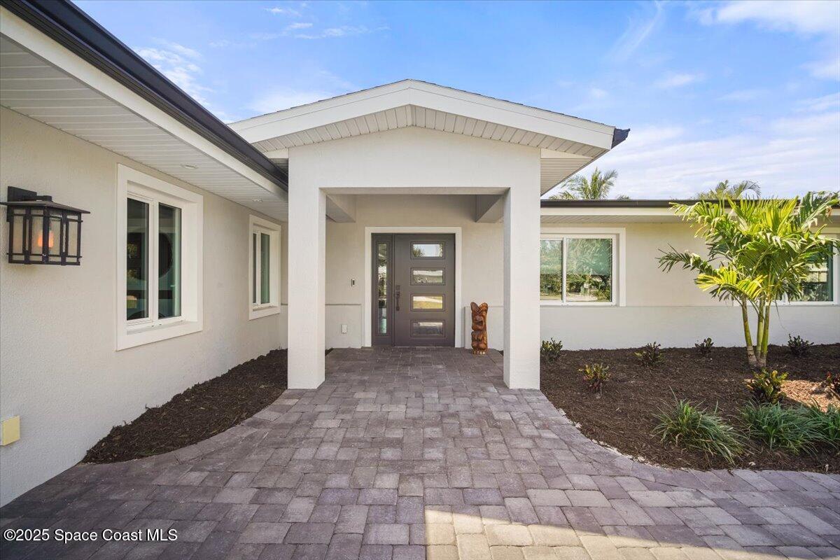 1125 Samar Road Cocoa Beach, FL 32931 - Photo 7 of 46 a view of a front door and a yard