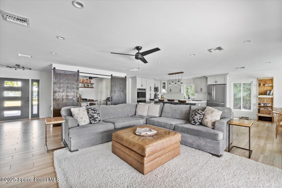 1125 Samar Road Cocoa Beach, FL 32931 - Photo 46 of 46 a living room with furniture and a ceiling fan