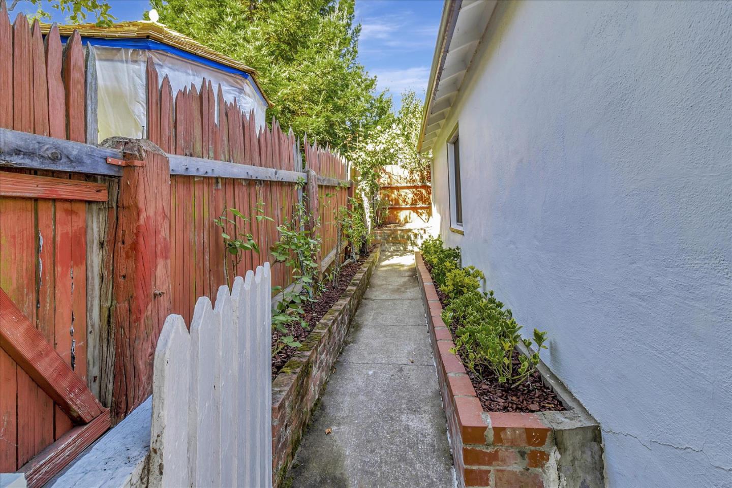 508 Park Boulevard Millbrae, CA 94030 - Photo 23 of 24 a view of a pathway of a house with wooden fence