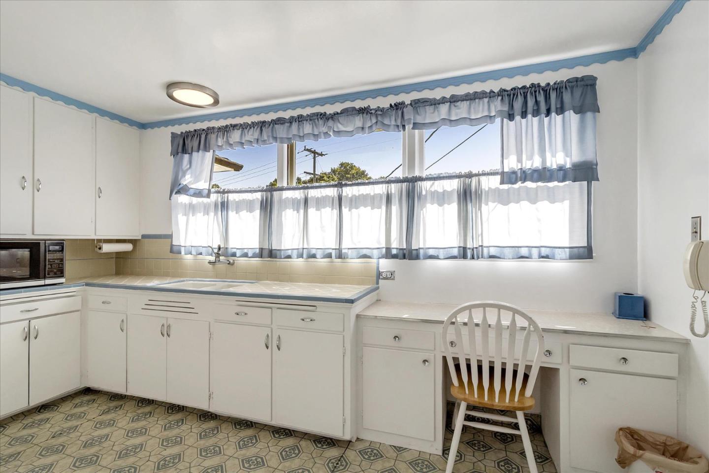 508 Park Boulevard Millbrae, CA 94030 - Photo 6 of 24 a kitchen with a window a sink and a cabinets
