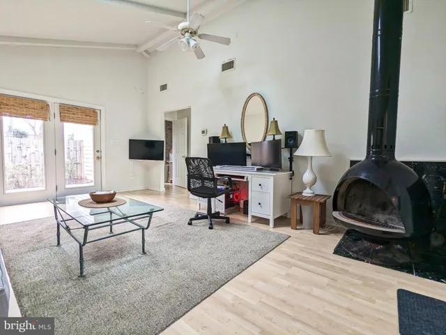 a living room with furniture a rug and a window