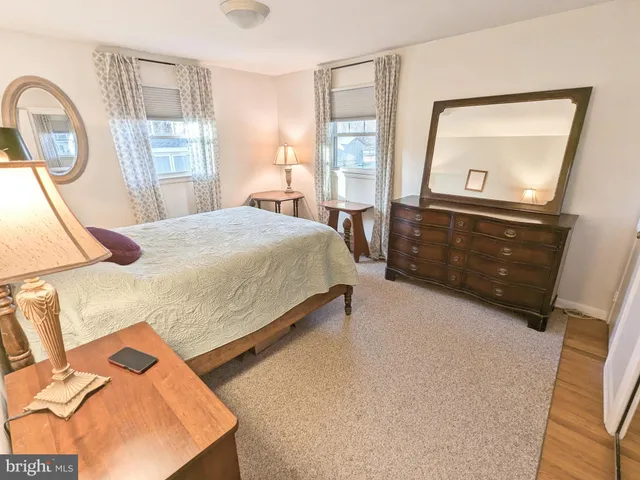 a bedroom with a bed and a mirror