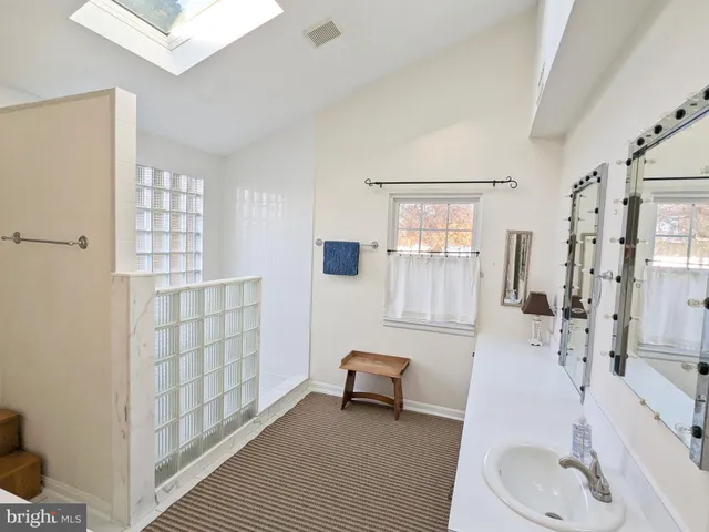 a bathroom with a sink double vanity and tub
