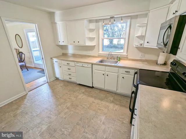 a kitchen with sink cabinets and window