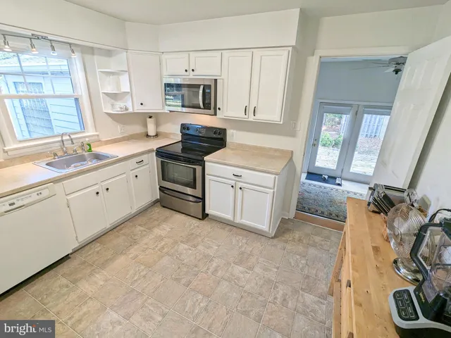 a kitchen with a sink appliances and cabinets
