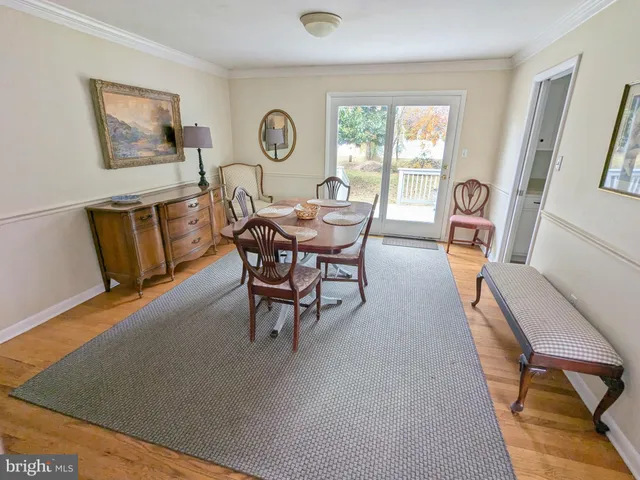 a living room with furniture a window and a clock