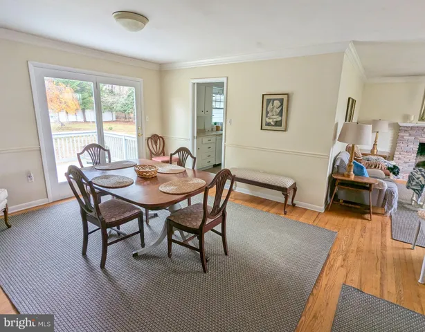 a dining room with furniture and wooden floor