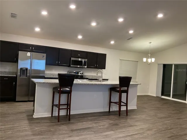 a kitchen with a sink stainless steel appliances and cabinets