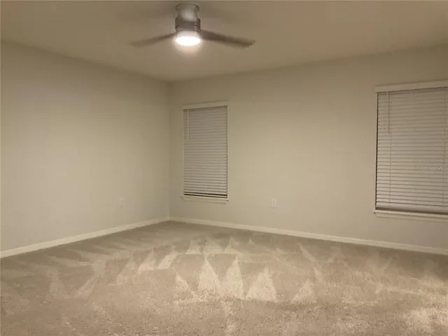 an empty room with a empty space and windows