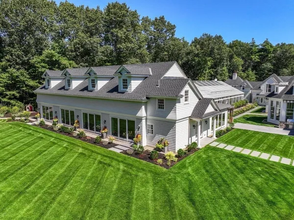 a aerial view of a house with a yard table and chairs