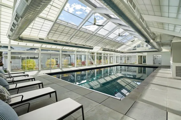 a view of a swimming pool with seating space