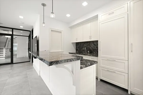 a kitchen with stainless steel appliances granite countertop a refrigerator and a stove top oven
