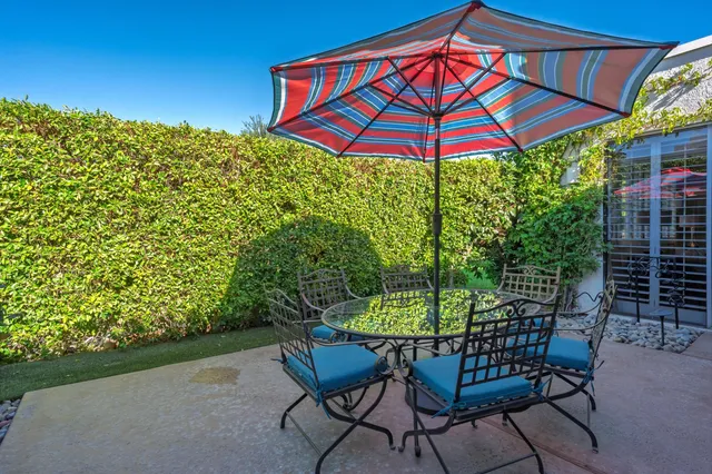 a view of a chair and table in the patio