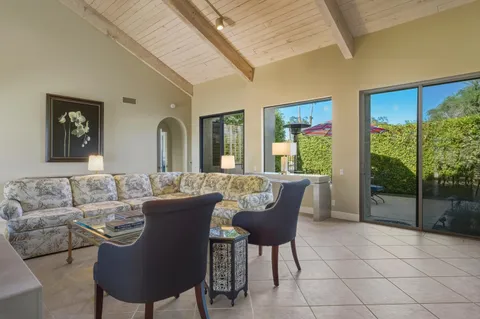 a living room with furniture and a painting on the wall
