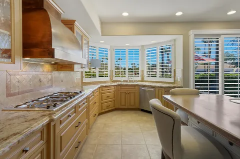 a dining room with a table chairs and kitchen view
