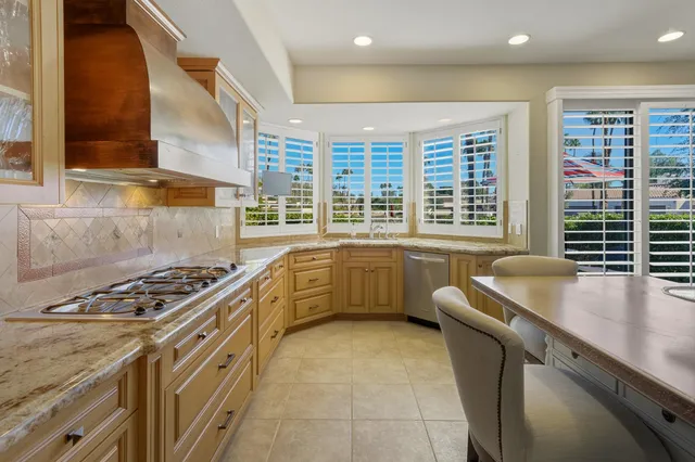 a dining room with a table chairs and kitchen view