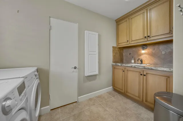 a bedroom with a bed a dresser and next to a window