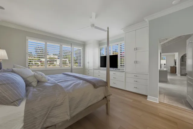 a spacious bedroom with a bed wooden floor and lamp