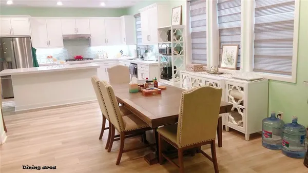 a dining room with furniture a window and wooden floor