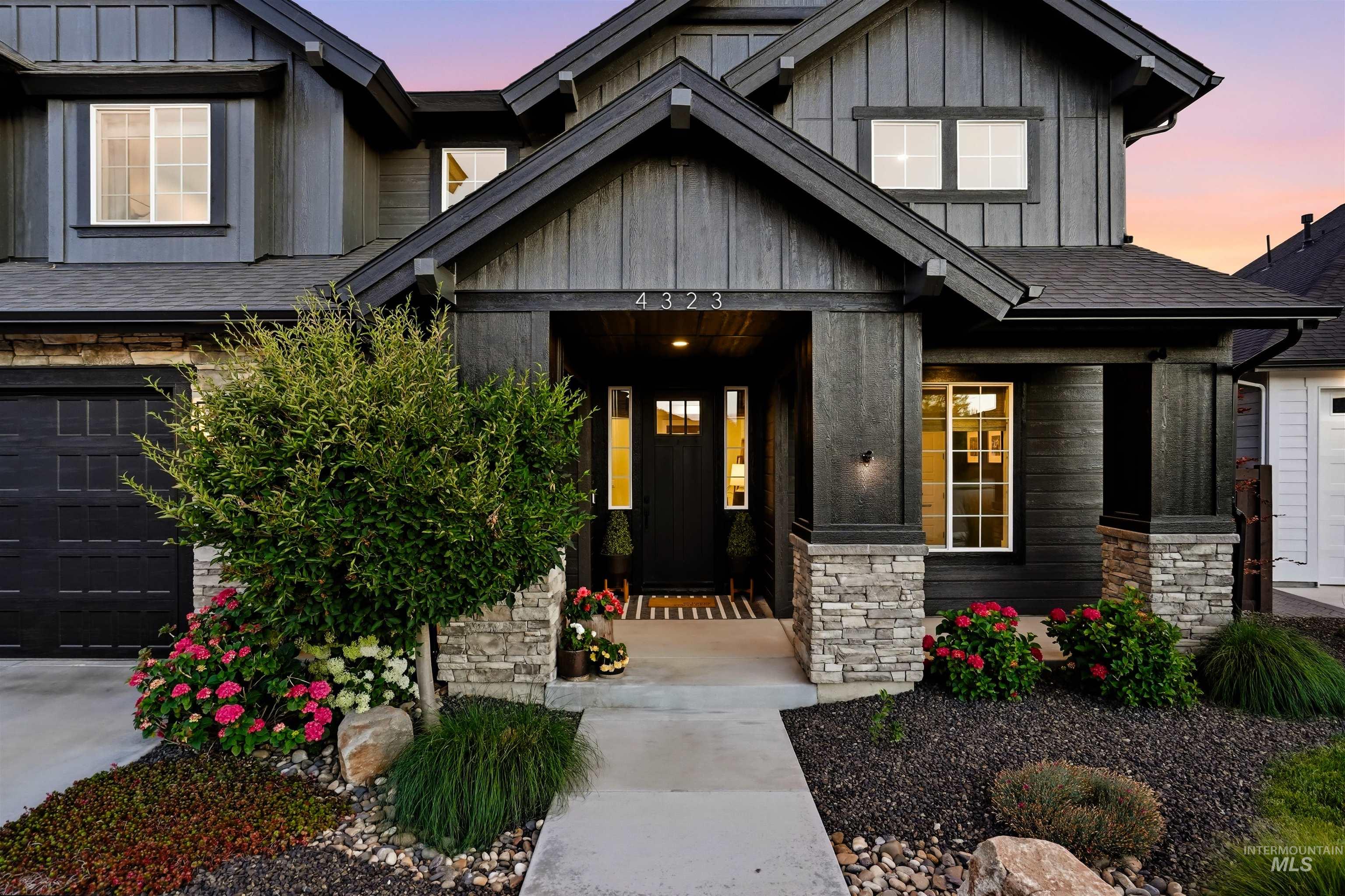 4323 West Ladle Rpds Drive Meridian, ID 83646 - Photo 3 of 49 Contemporary exterior featuring dark vertical siding and stone accents