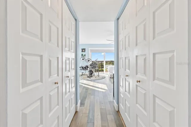 a view of a hallway with a livingroom and furniture
