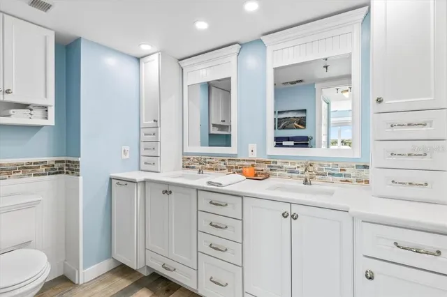 a bathroom with a sink a toilet and a mirror