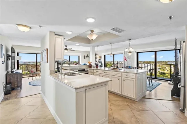 a kitchen with counter top space appliances and a view of living room