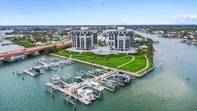 an aerial view of a house with a garden and lake view
